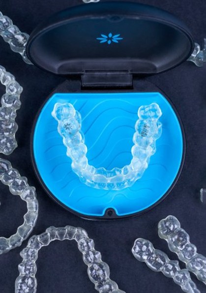 a protective case with Invisalign aligners surrounding it