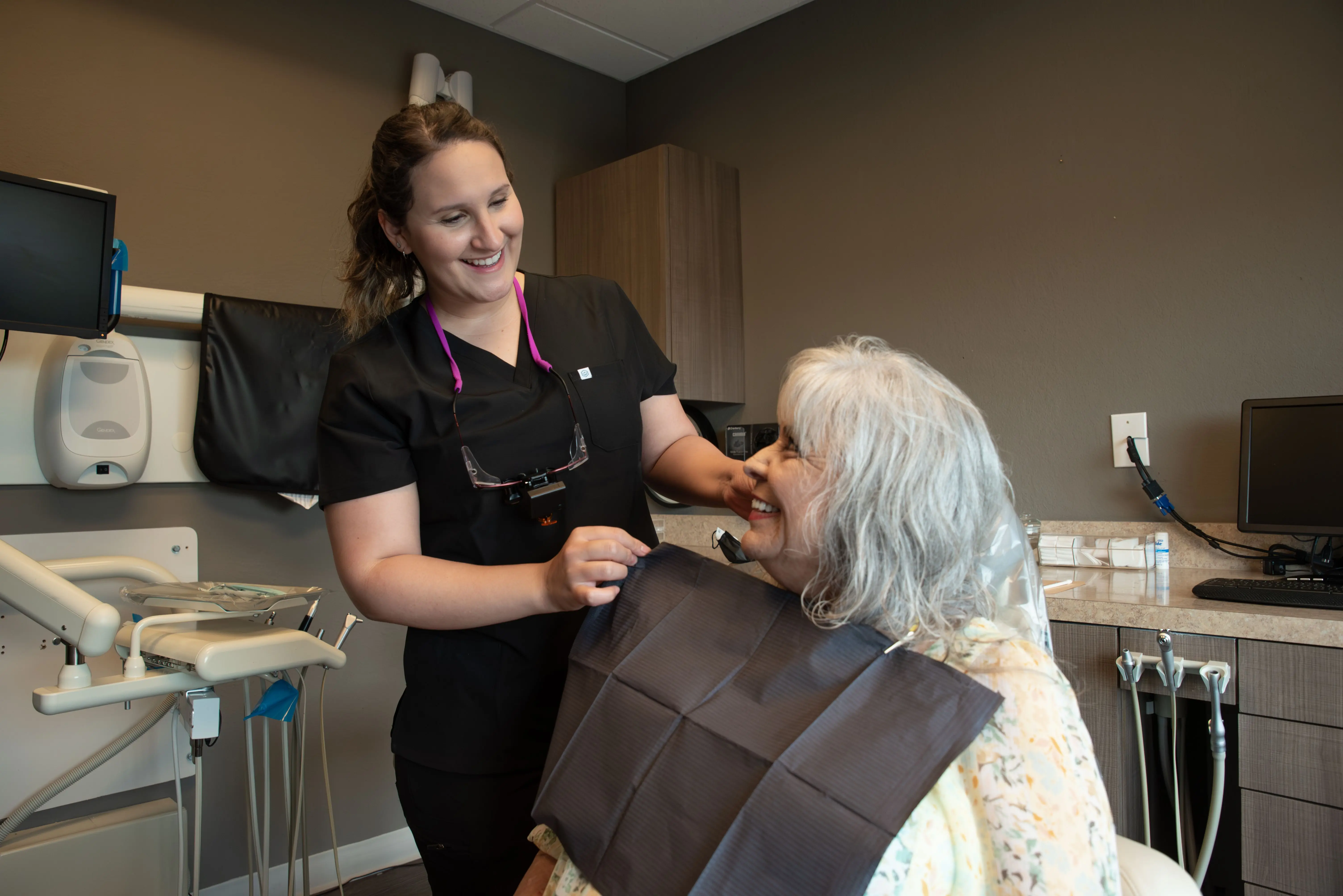 Woman receiving teeth whitening treatment at Lumiescence Dentistry