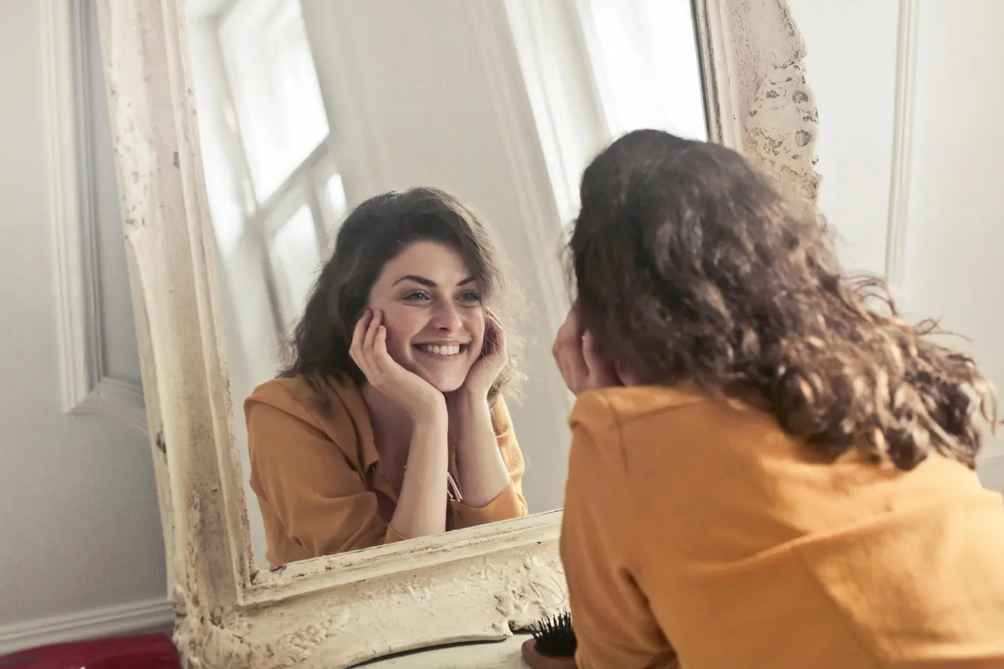 woman smiling in the mirror