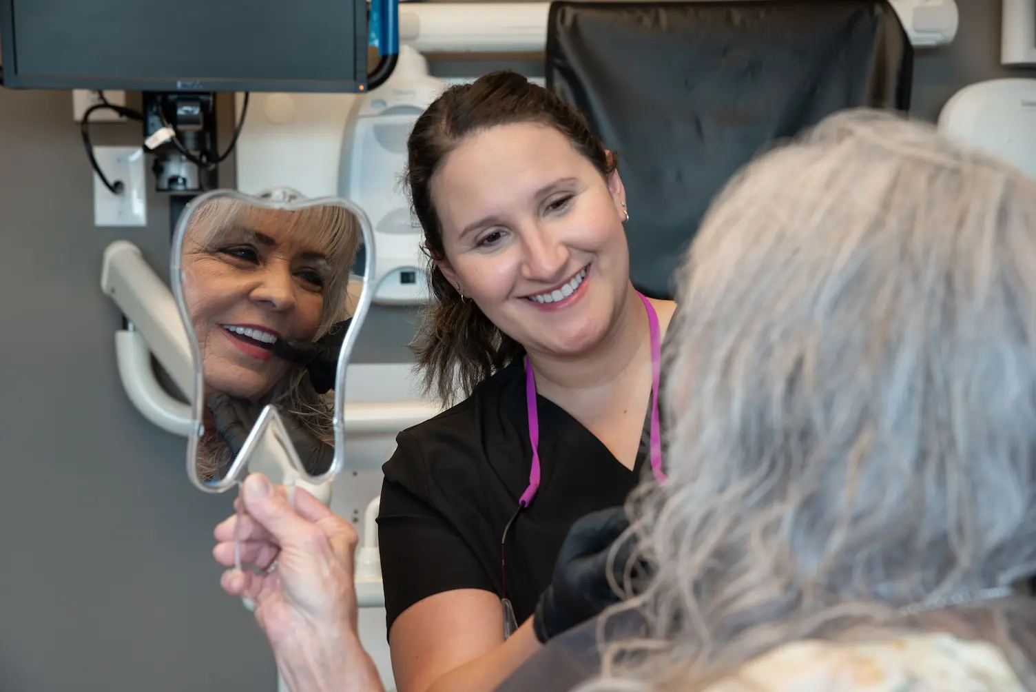 Woman getting dental cleaning at Luminescence Dentistry