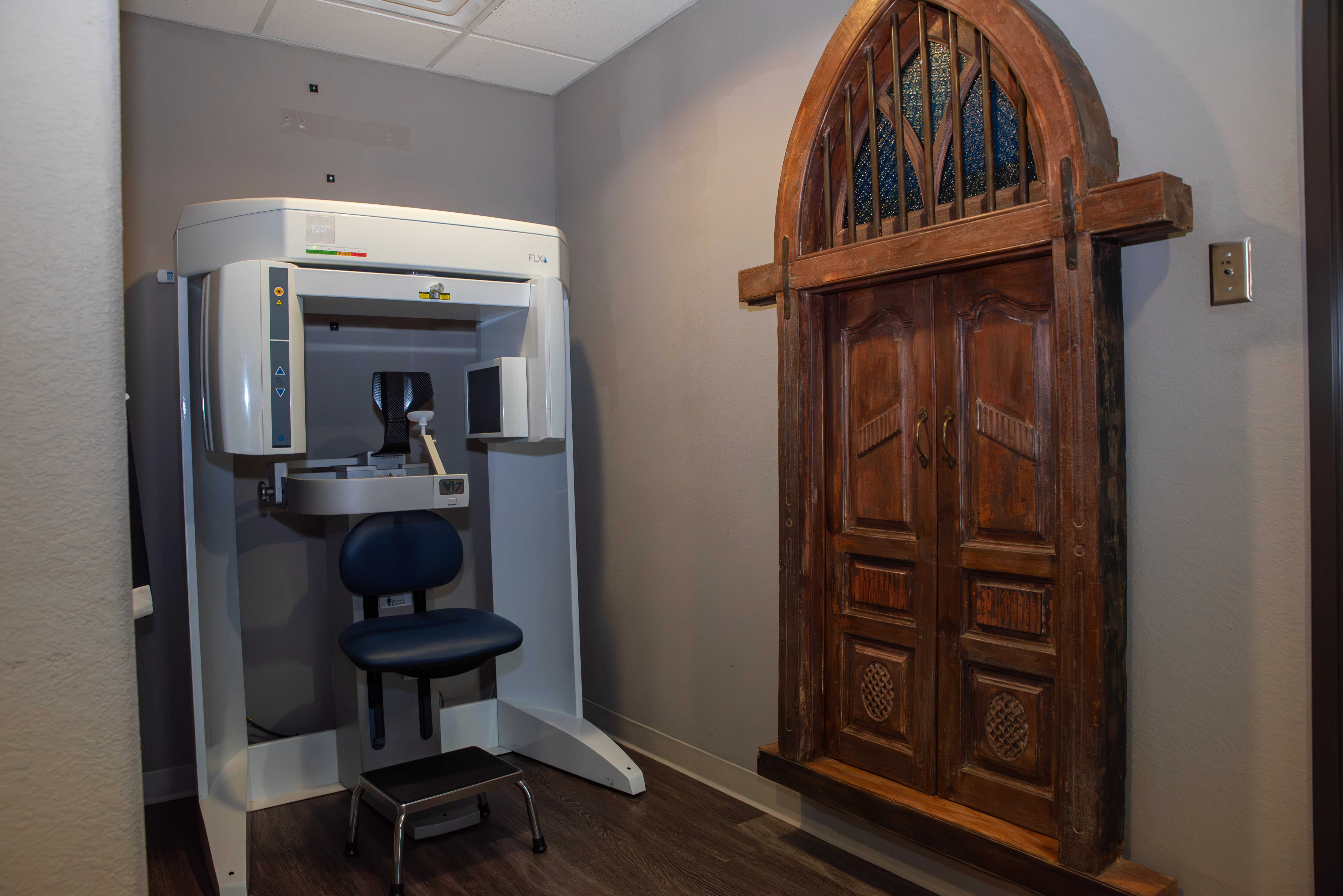 A medical technology instrument next to an elegant brown exit door